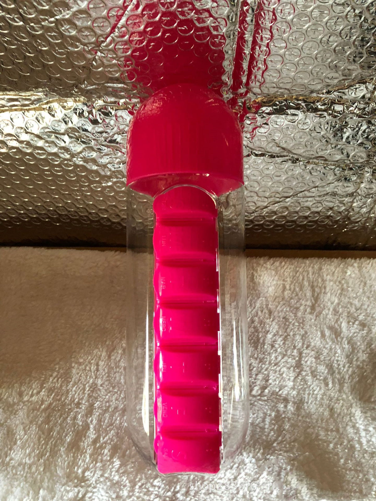 Close-up of pink DailyDose 2-in-1 pillbox water bottle, real customer photo showing the ridged pill compartment