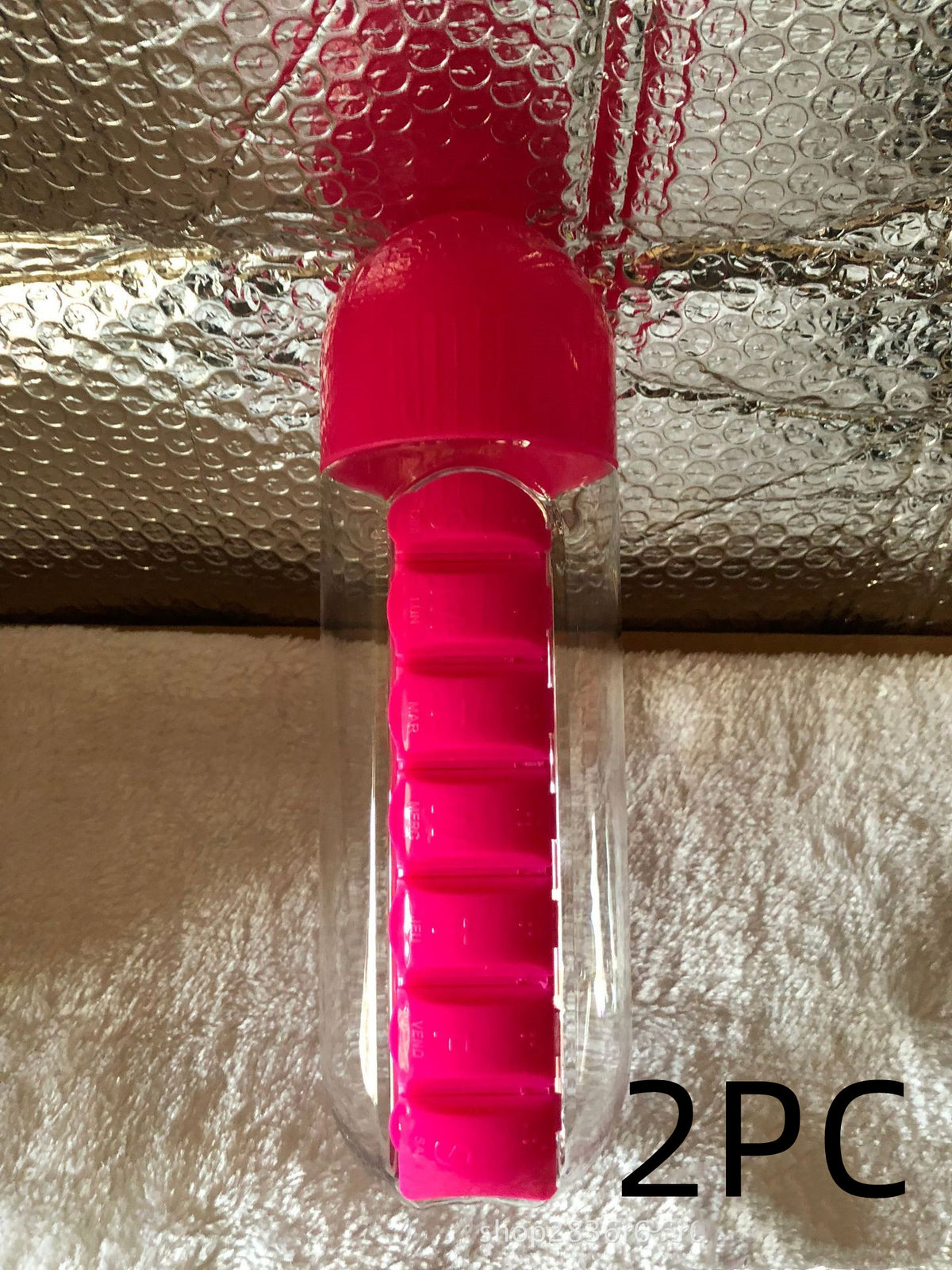 Pink DailyDose pillbox water bottle 2-pack, real customer photo on a textured blanket