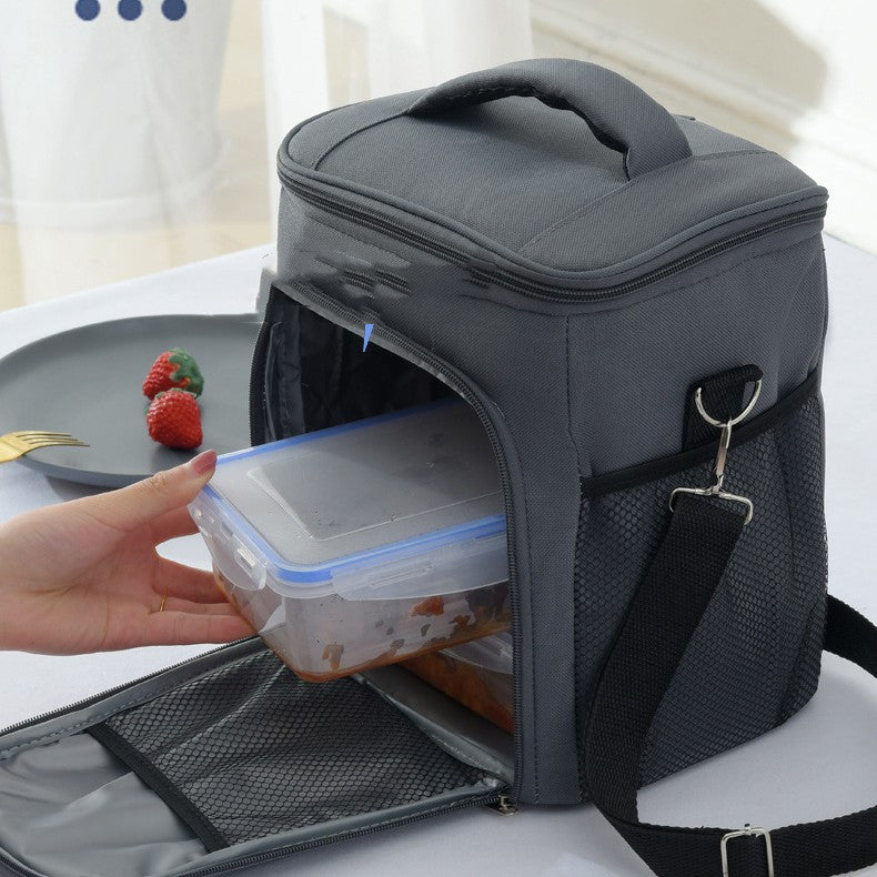 Hand placing food container into gray ChillPack insulated lunch bag interior