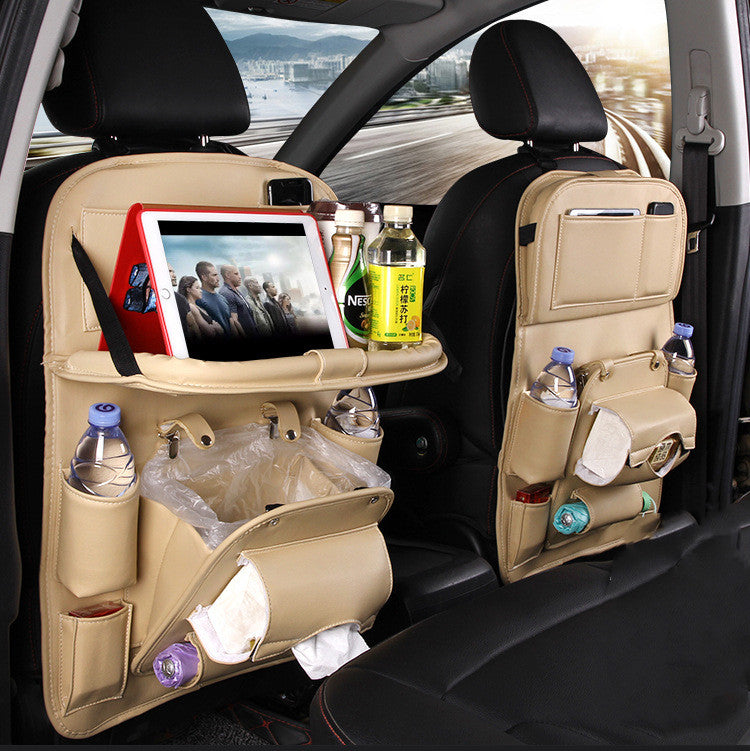 Beige RoadTrip car backseat organizer set on both front seats with fold-out tablet tray and drink pockets
