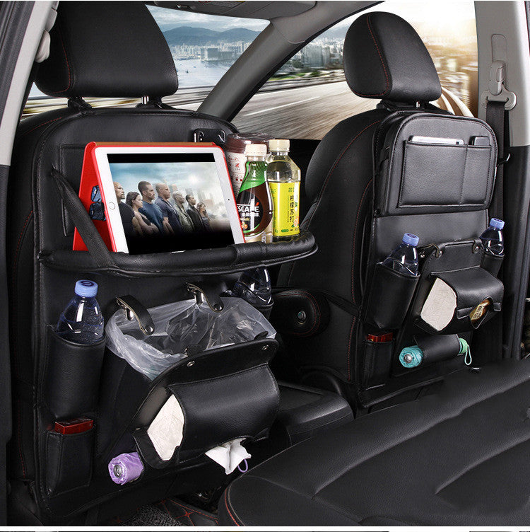 Black leather RoadTrip car backseat organizer set with red stitching, tablet tray, and multiple storage pockets on both front seats
