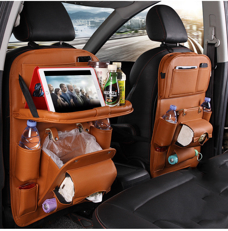 Brown RoadTrip car backseat organizer set on both front seats with tablet tray, trash bag, and drink pockets