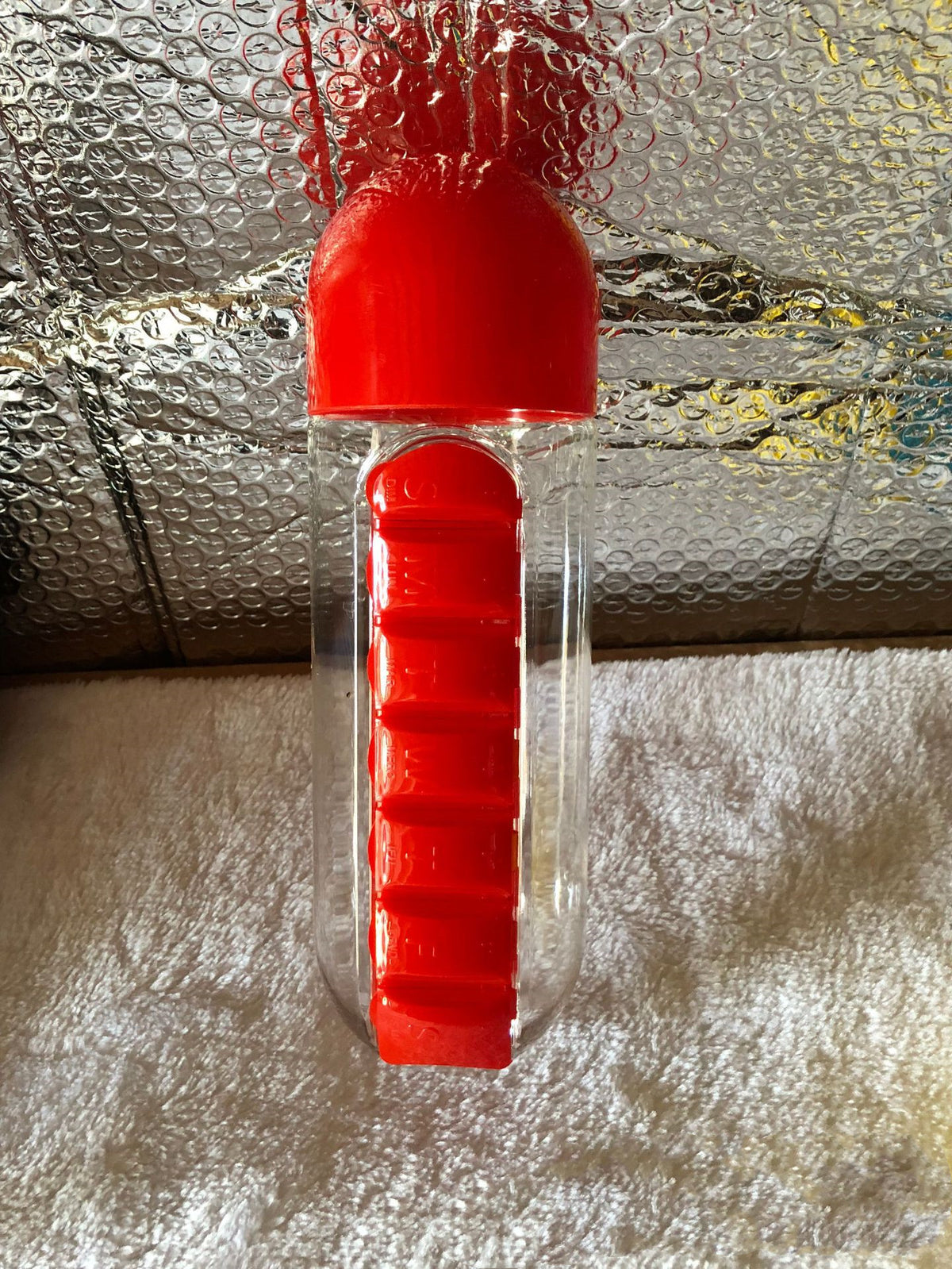 DailyDose 2-in-1 pillbox water bottle collage showing all 5 color options styled with fruit and a notebook for scale