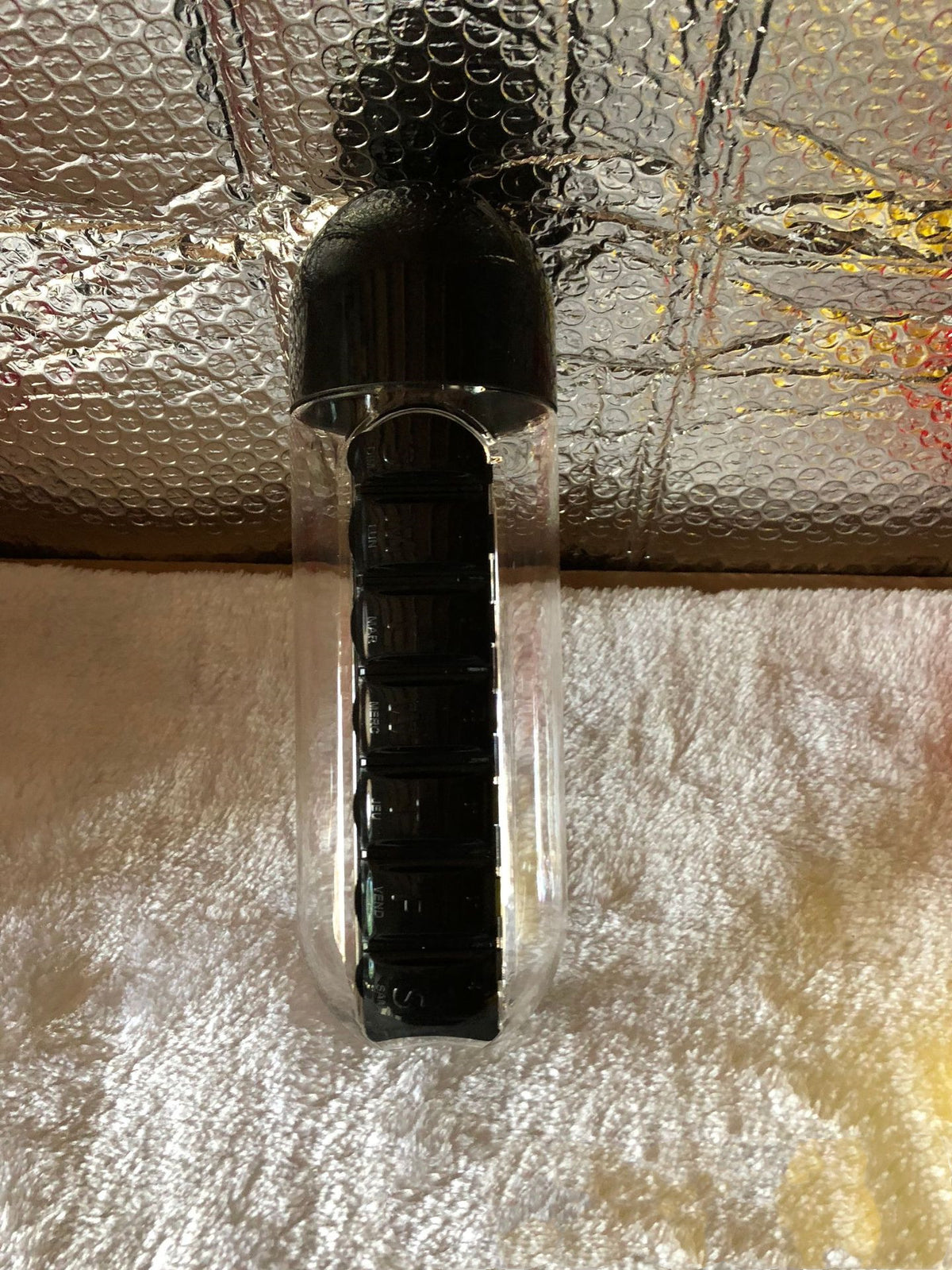 Black DailyDose pillbox water bottle real-life customer photo showing the black colorway