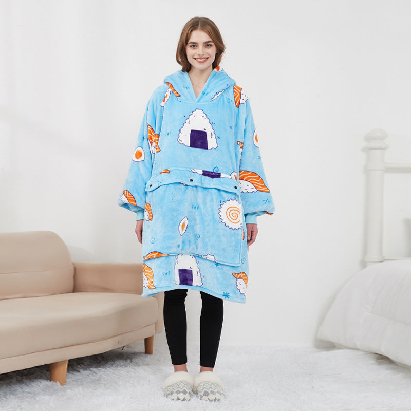 Woman wearing blue sushi print CozyGlow wearable heated hoodie blanket in white bedroom