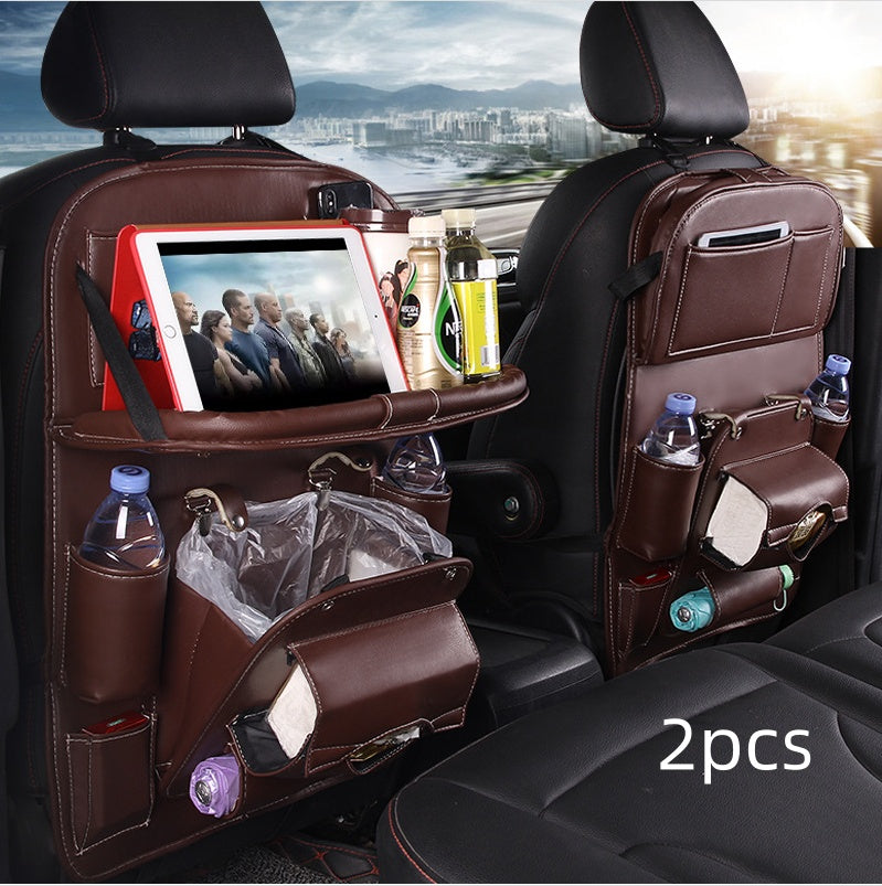 Dark brown RoadTrip car backseat organizer 2-piece set installed on front seats with tablet tray and trash bag