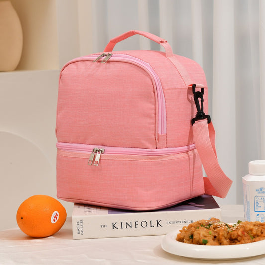 Pink ChillPack insulated lunch bag with food and orange on table