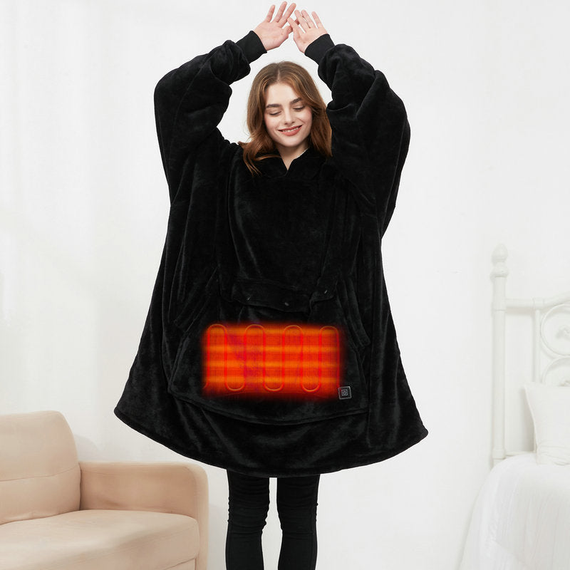 Woman wearing black CozyGlow heated hoodie blanket showing glowing heated front pocket panel