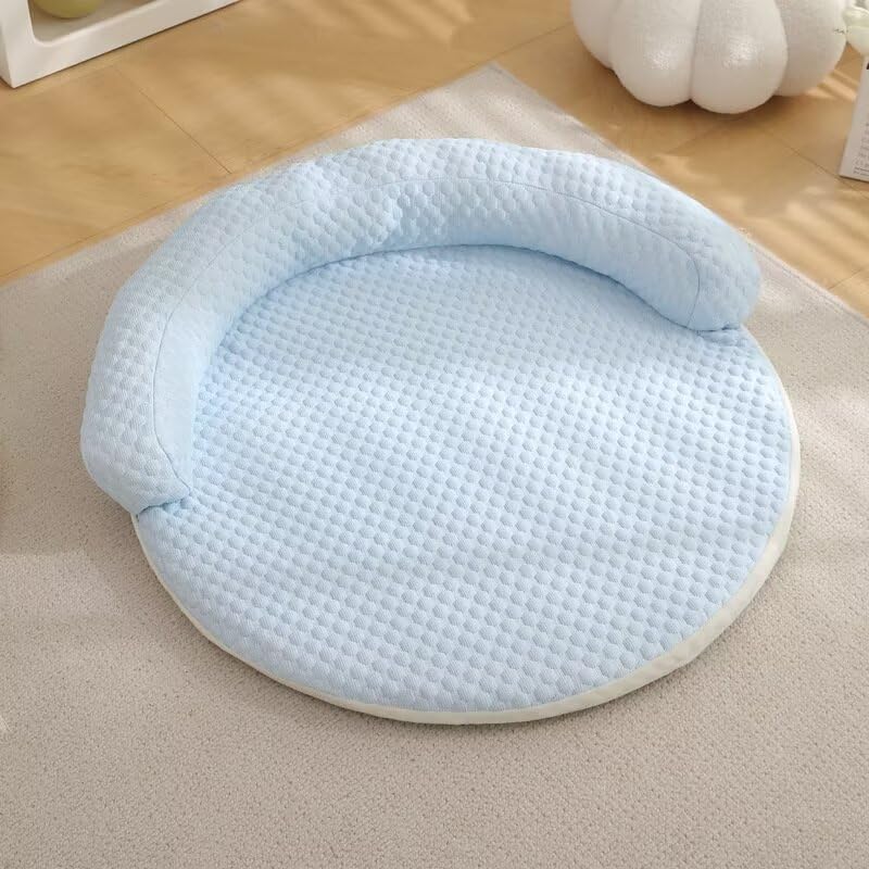Blue quilted CoolPaws pet cooling mat, round plush bed for dogs and cats on wood floor