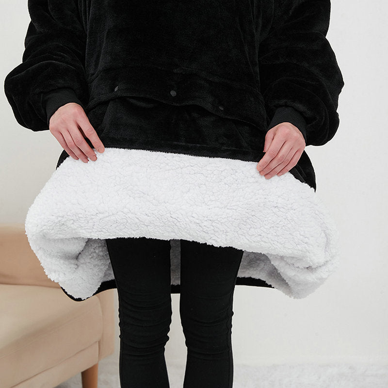 Close-up of black CozyGlow hoodie blanket hem showing soft sherpa fleece lining